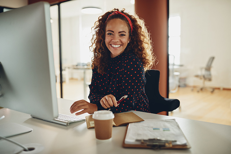 woman smiling at desk